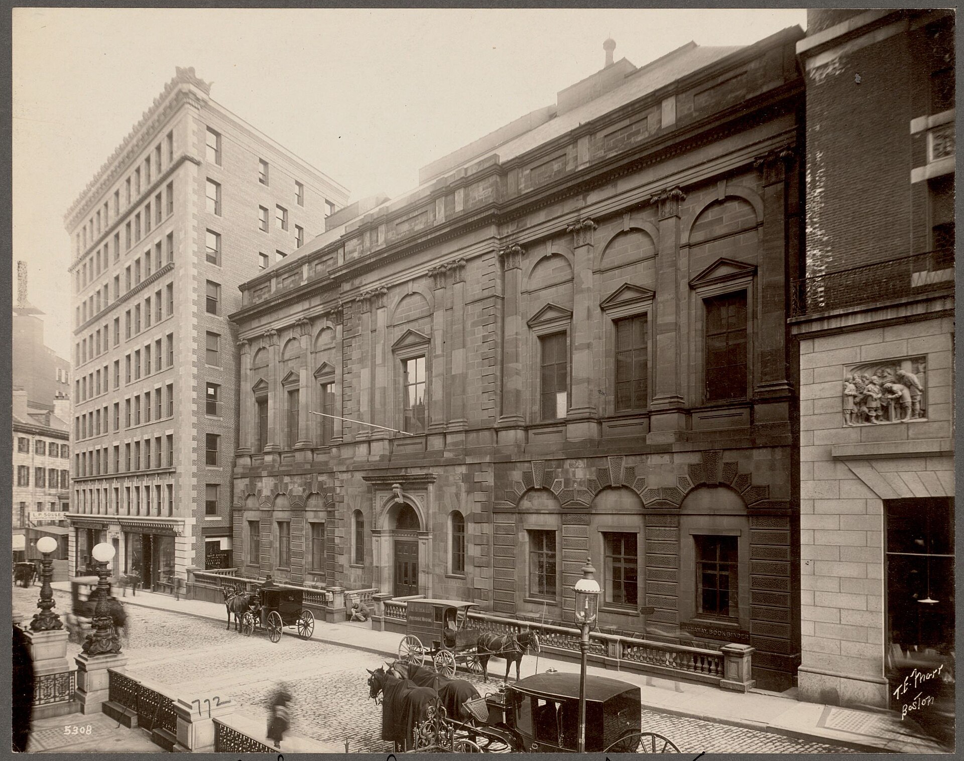 Historic photo of the Boston Athenaeum's sandstone facade on Beacon Street, with horse-drawn carriages