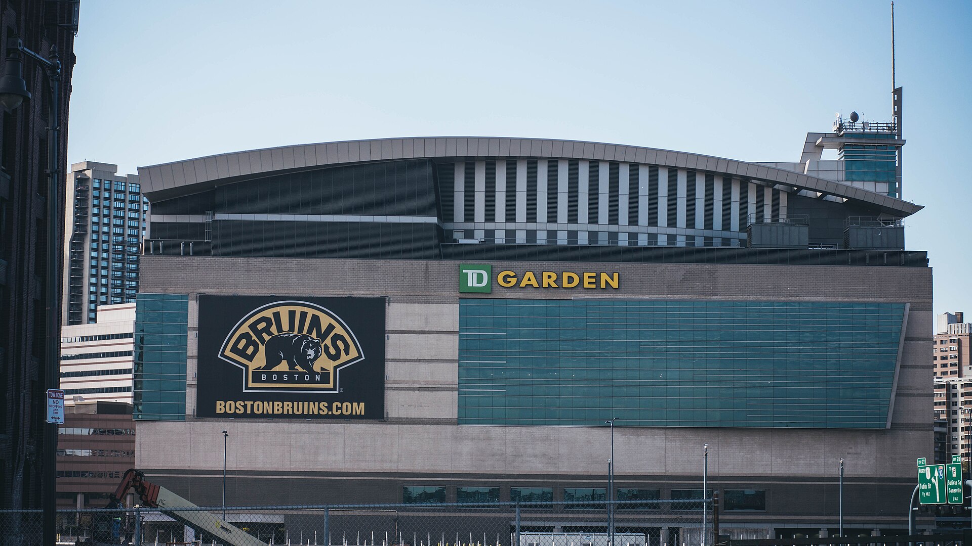 TD Garden's facade with a large Bruins logo banner beside the TD Garden sign
