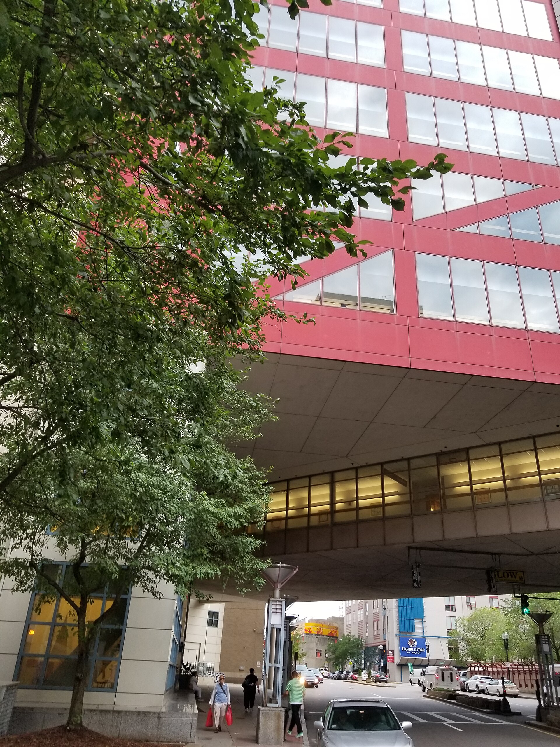 Tufts Medical Center's red-framed building and walkway over a downtown Boston street